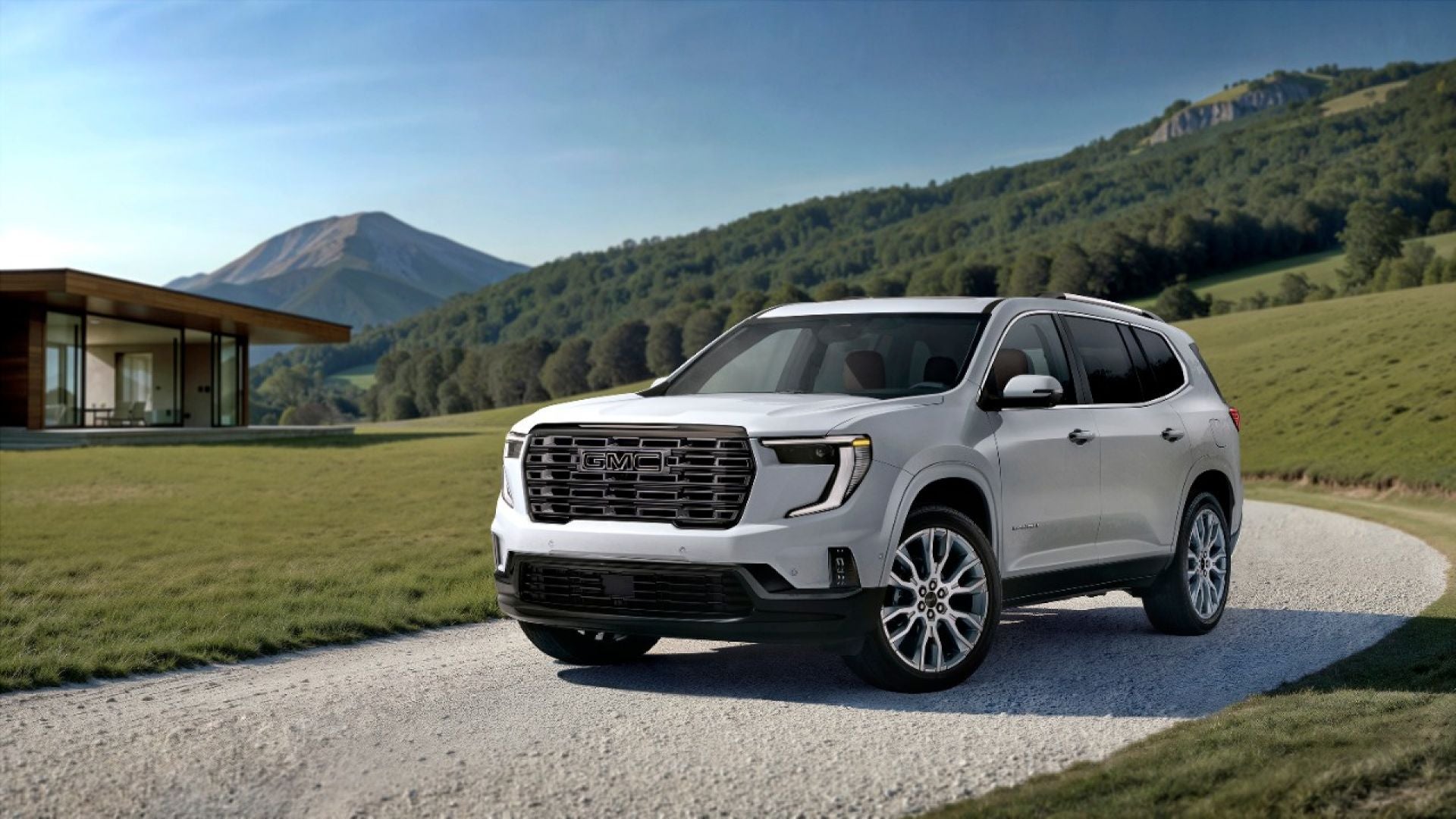 GMC Acadia Denali Ultimate front three-quarter view on a gravel drive