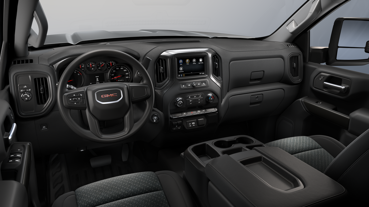 GMC Sierra work truck interior with cloth seats, analog gauges, and center touchscreen