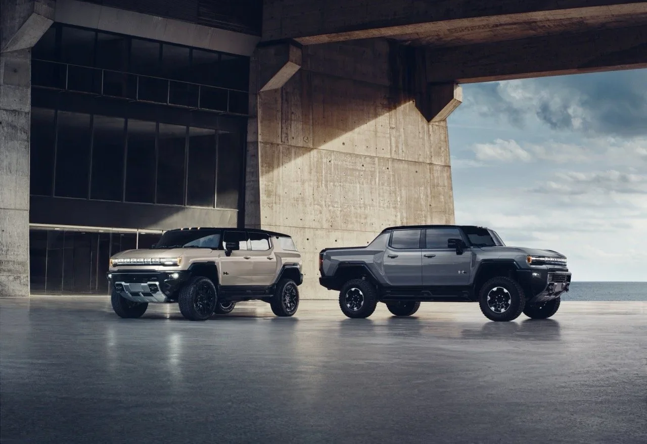 GMC Hummer EV SUV and Hummer EV Pickup parked under a concrete structure