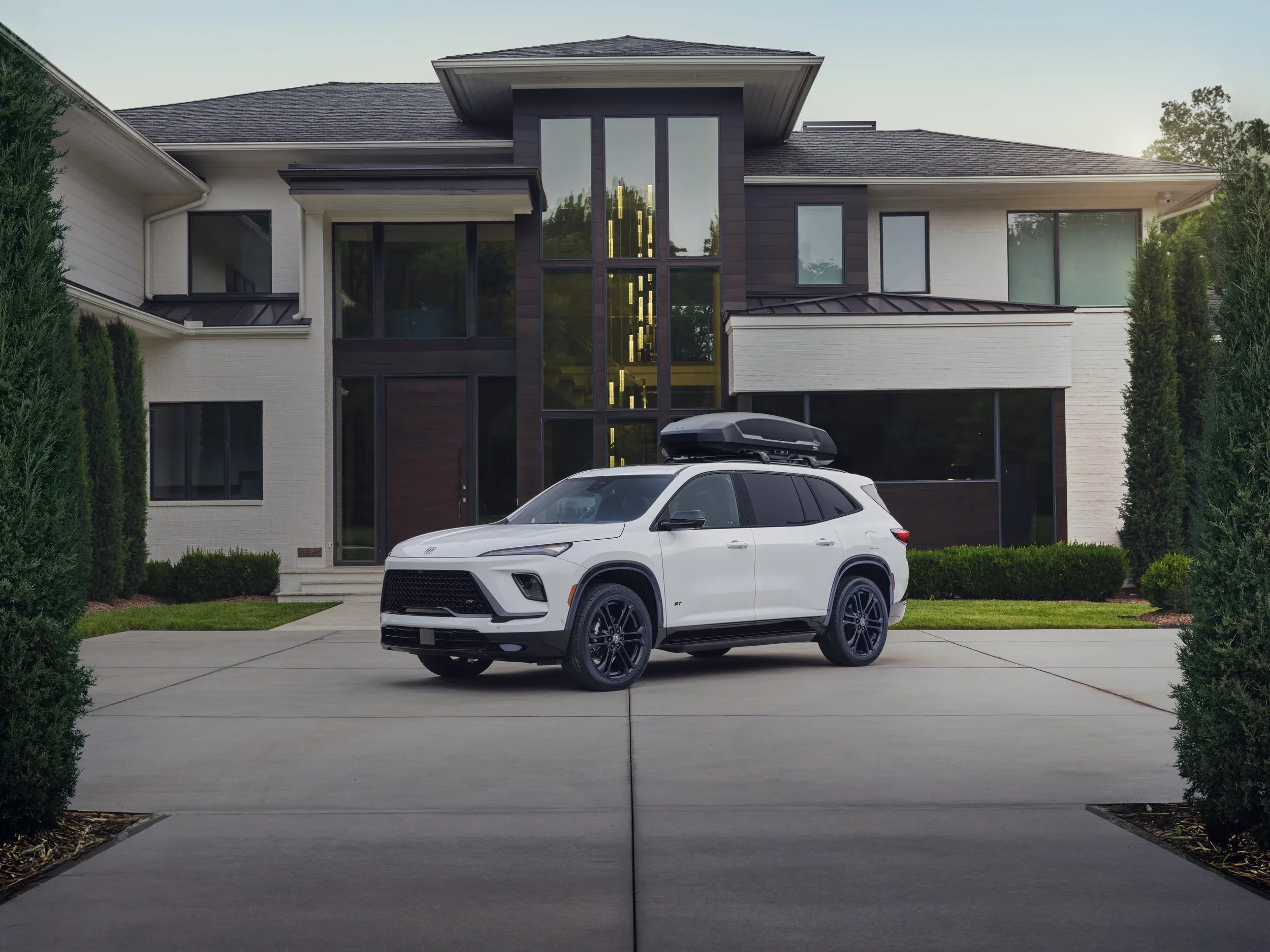 White 2025 Buick Enclave ST with black roof cargo box parked in driveway