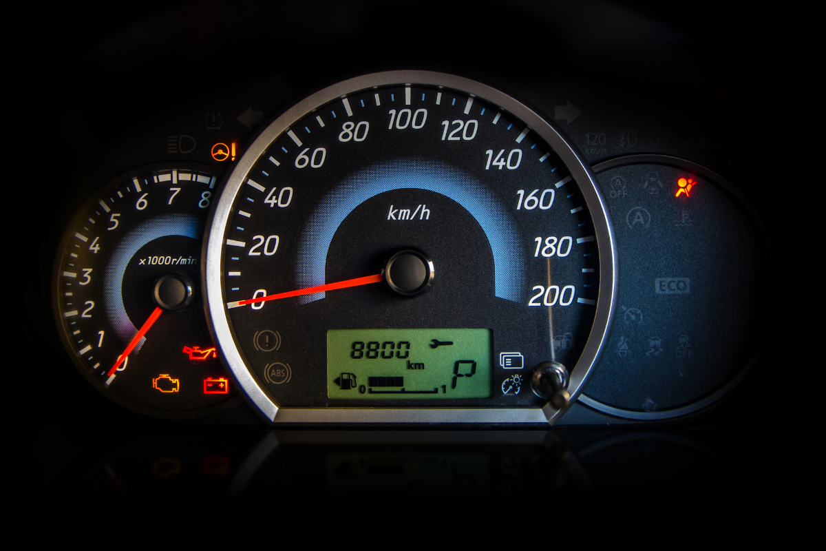 red dashboard warning light illuminated on vehicle instrument panel