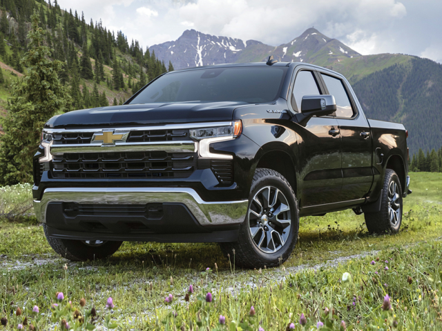A Chevrolet Silverado 1500 parked outside near some mountains and hills