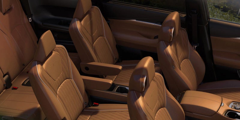 Premium SUV interior with tan leather captain’s chairs and spacious three-row seating.