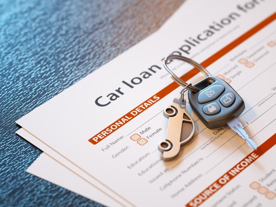 car keys sitting on top of a car loan application 