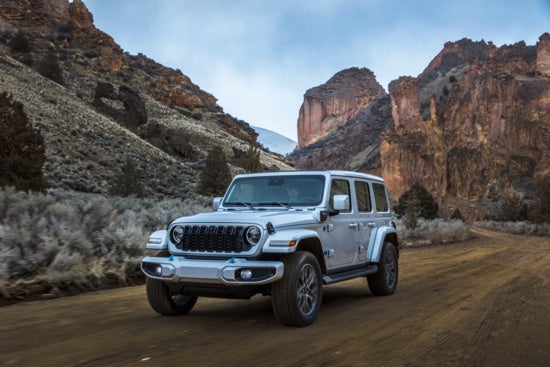 a jeep wrangler driving through the mountains 