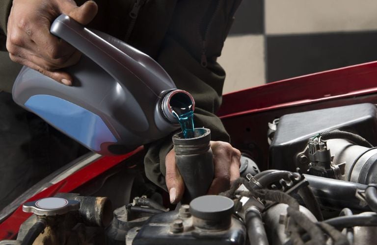Mechanic pouring oil
