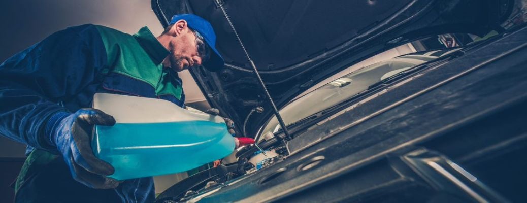 Mechanic pouring cooling oil