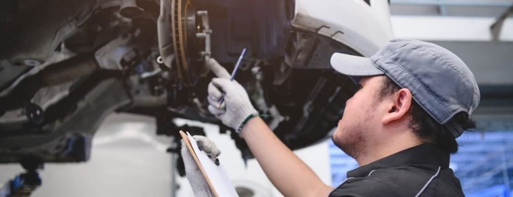 A mechanic checking the brakes of a car