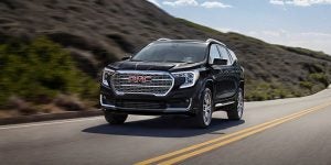 2024 GMC Terrain driving down the road. 