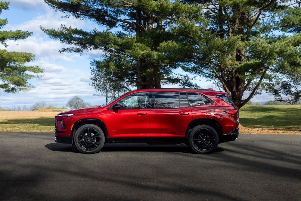 Red 2026 Buick Enclave parked in front of trees