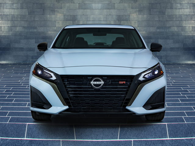 Front view of a white 2024 Nissan Altima parked in a brick garage. | Nissan dealer in Norfolk, VA | Banister Nissan of Norfolk
