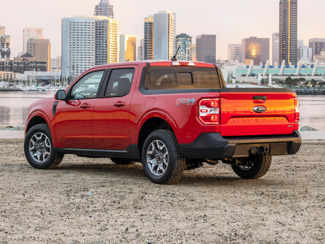 Rear profile view of a red 2024 Ford Maverick parked with tall buildings in the background. | Ford dealer in Altoona, PA | Courtesy Ford Lincoln