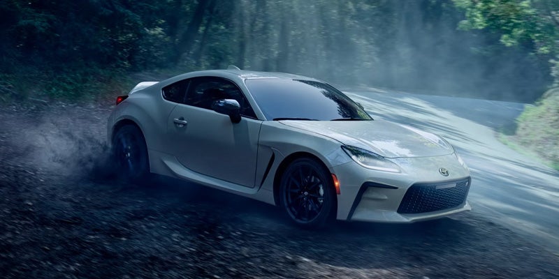 An all new White 2025 Toyota GR86 drifting on a country backroad. - Phil Meador Toyota Pocatello, ID