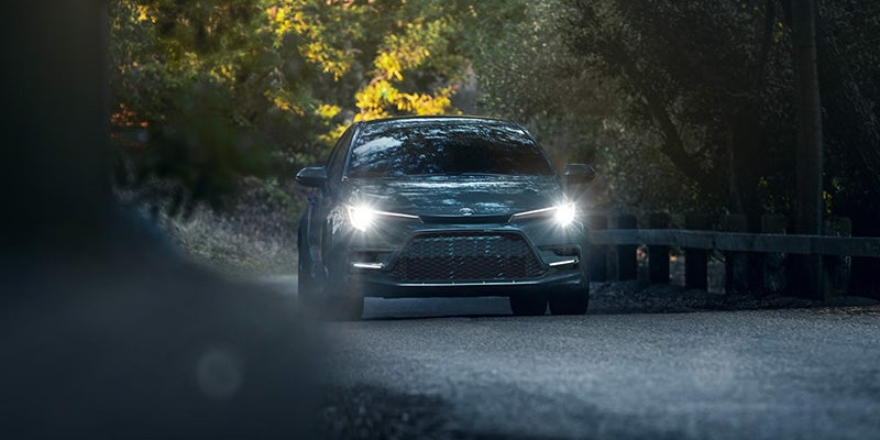 2025 toyota corolla driving on dirt road with light on