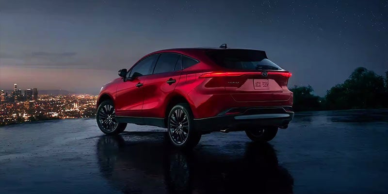 An all-new Red 2024 Toyota Venza parked atop a hill overlooking the city at dusk. - Phil Meador Toyota Pocatello, ID