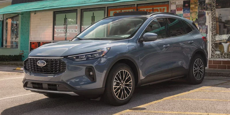 A silver 2026 Ford Escape parked in front of a store.