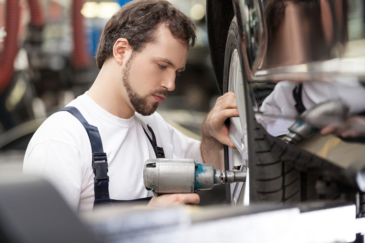 Auto mechanic at work shop. Confident mechanic working at the re