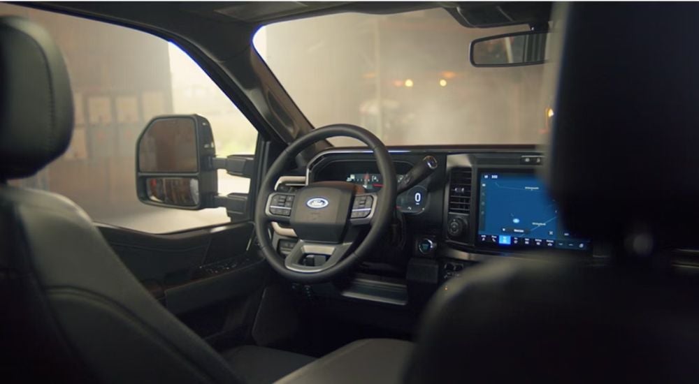 2026 Ford F-250 front interior showing the steering wheel and infotainment.
