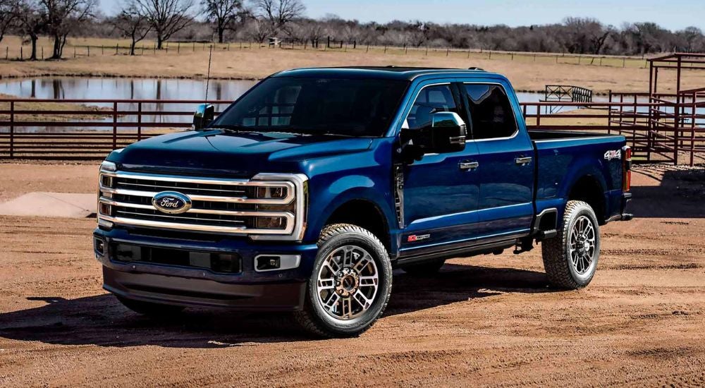 Blue 2026 Ford F-250 4-Door on a ranch.