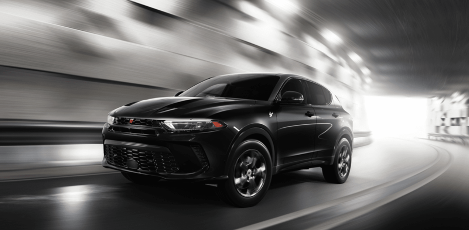 A black Dodge Hornet SUV accelerating through a tunnel