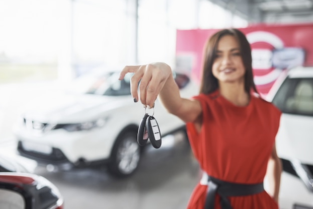 Dealership representative handing car keys to customer