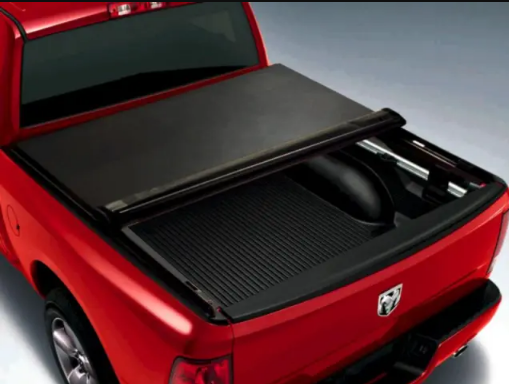 Retractable tonneau cover partially open on red pickup truck bed