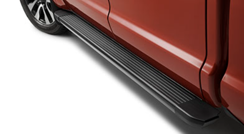 Running board installed on red pickup truck side