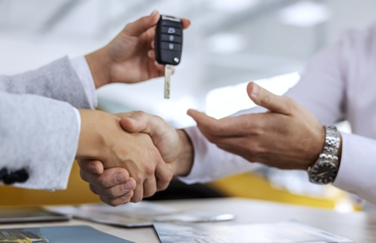 Customer receiving car keys after auto financing approval