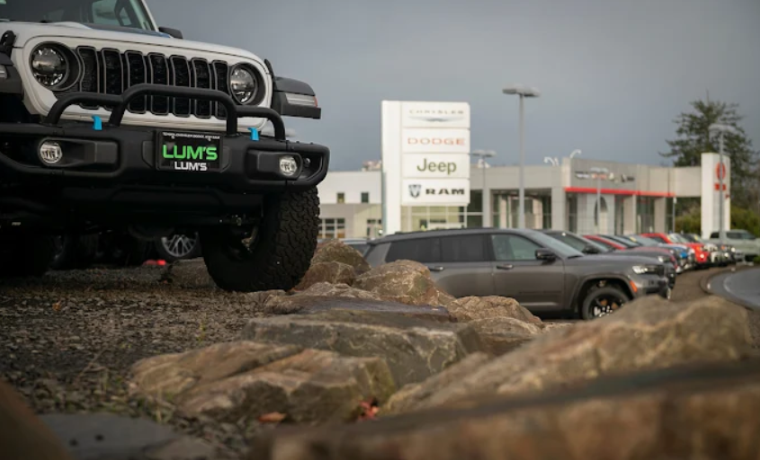Close-up front view of a white off-road Jeep parked on rocks