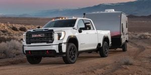 A 2025 GMC Sierra HD driving through a desert.