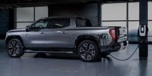The 2025 GMC Sierra EV parked at a charging station. 