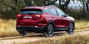 2024 GMC Terrain driving on a country road.