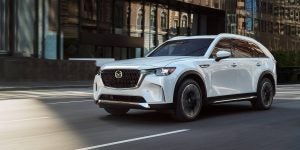 a white 2024 Mazda CX-90 PHEV driving through city streets | Vancouver, WA