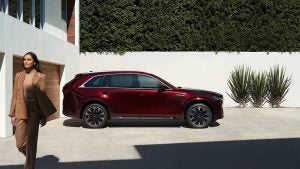 left profile of a wine red 2024 mazda cx-90 parked in a modern home driveway | Vancouver, WA