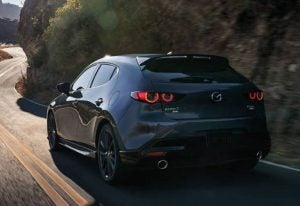 rear view of a 2024 Mazda3 Hatchback driving through a country road | Vancouver, WA