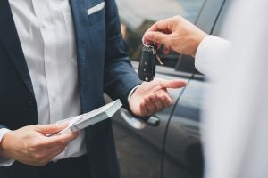 Closeup,Hand,Giving,A,Car,Key,And,Money,For,Loan | Vancouver, WA