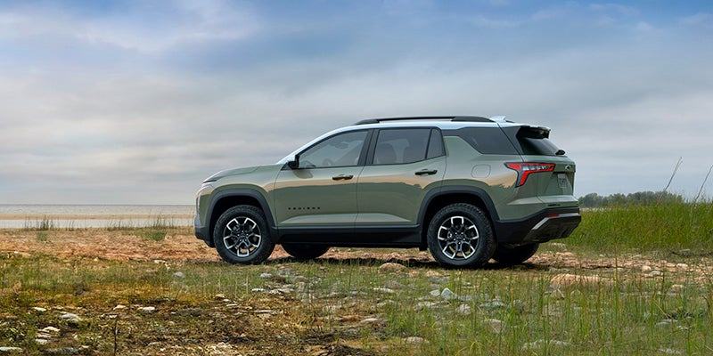 a green 2025 Chevrolet Equinox parked in a grassy field