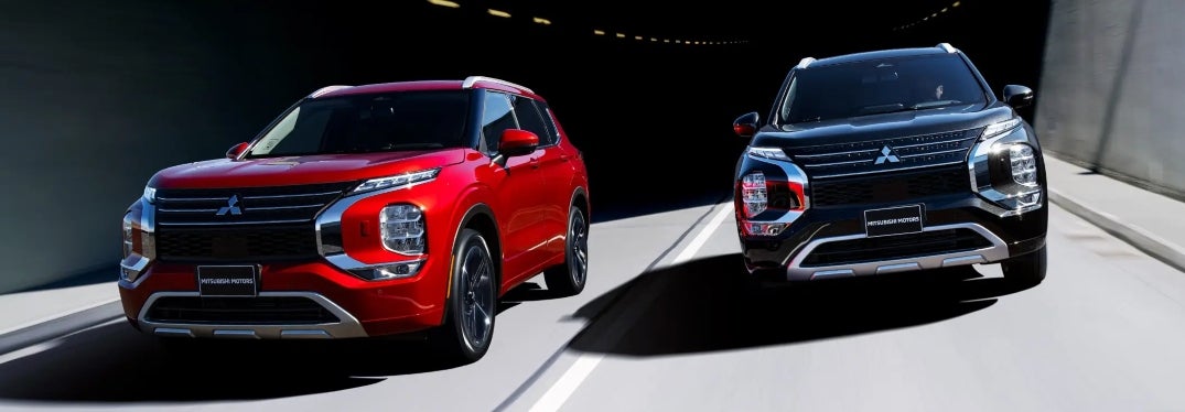 Two Mitsubishi Outlanders Driving on Road Side by Side