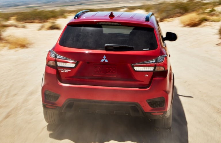 2023 Mitsubishi Outlander Sport Driving in Desert Back View