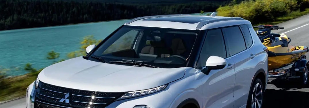 White 2024 Mitsubishi Outlander Towing Jet Ski