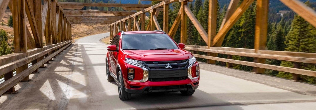 Red Outlander Sport Driving on Bridge