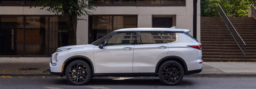 Side Profile of White 2024 Mitsubishi Outlander Parked on Street