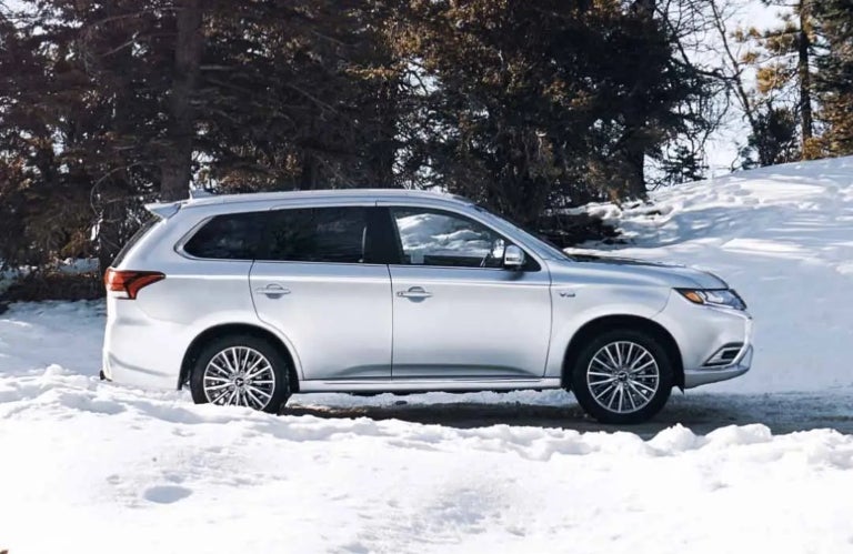 White 2022 Mitsubishi Outlander PHEV parked in Snow