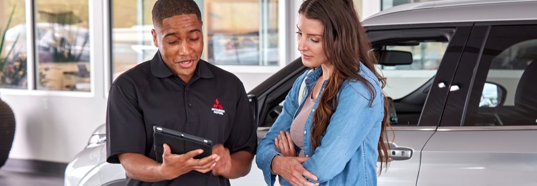 Mitsubishi Technician Showing Woman a Tablet Screen