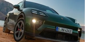 A 2025 Porsche Macan driving down a canyon road.