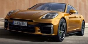 The 2025 Porsche Panamera driving down the street.