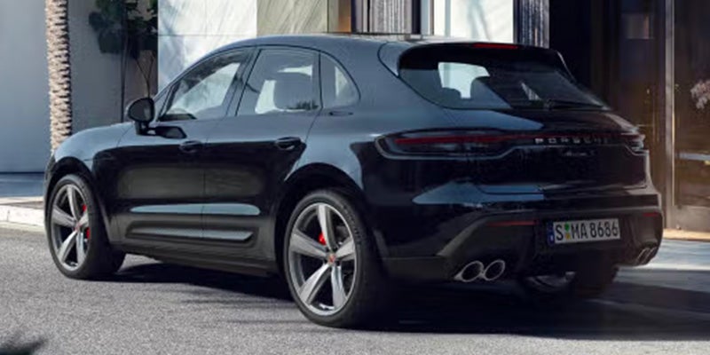 2026 Porsche Macan in black parked on a stylish street.