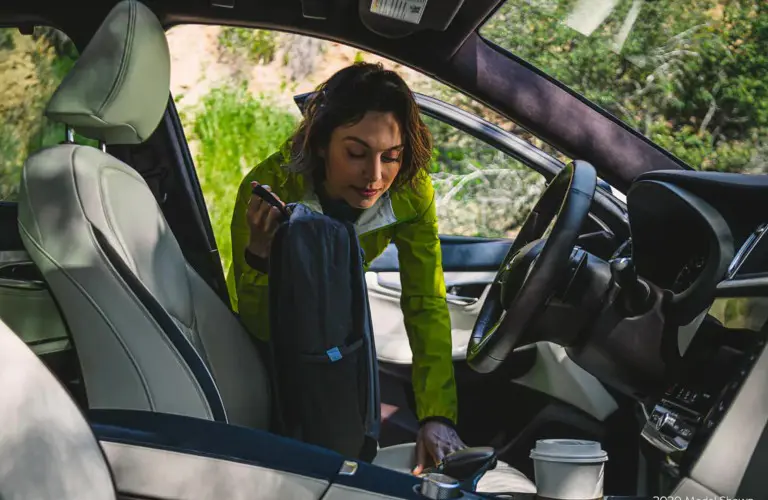 2021 INFINITI QX50 interior front seat with woman in yellow getting in