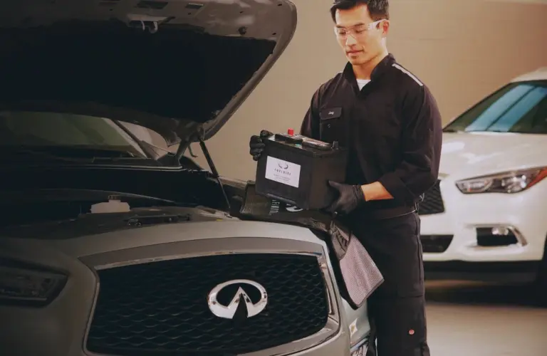 Service technician replacing battery in an INFINITI