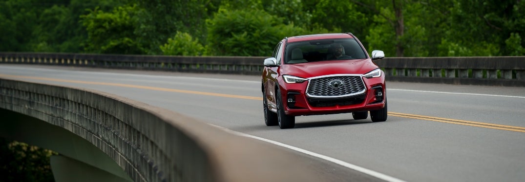 Red 2024 INFINITI QX55 Driving on Bridge Highway